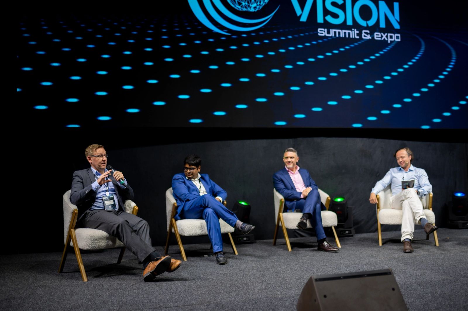WHIS leaders on a summit panel stage